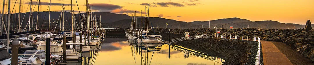 Airlie beach harbour under orange sunset