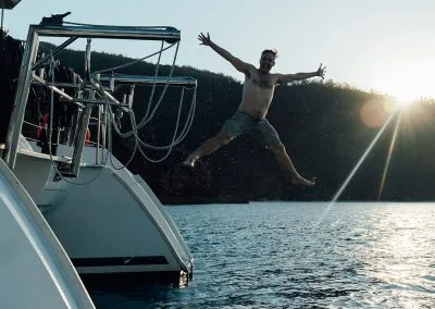 Man jumping off boat into the water