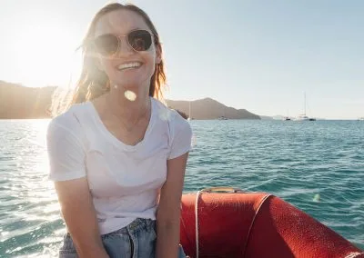 Woman smiling riding a dinghy