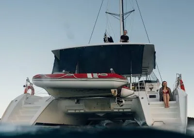 Looking up at people sitting on a boat from the water